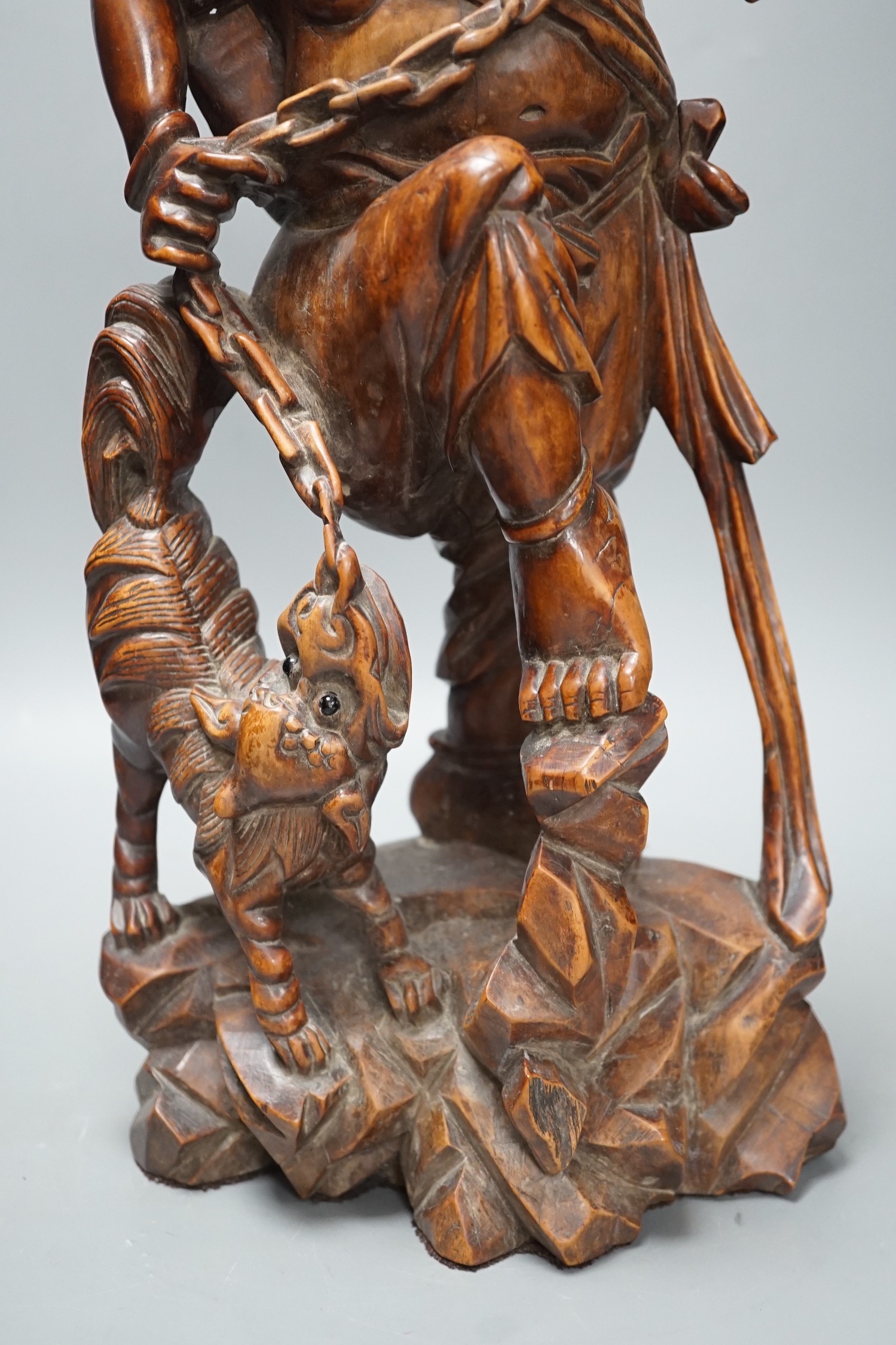 A large Chinese hardwood figure of Liu Hai, early 20th century, 47cm